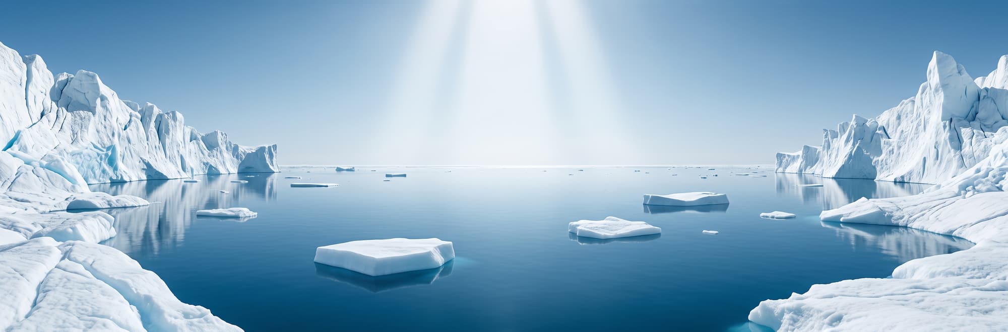 Témpanos de hielo flotando sobre agua serena, bajo una luz blanca vertical.